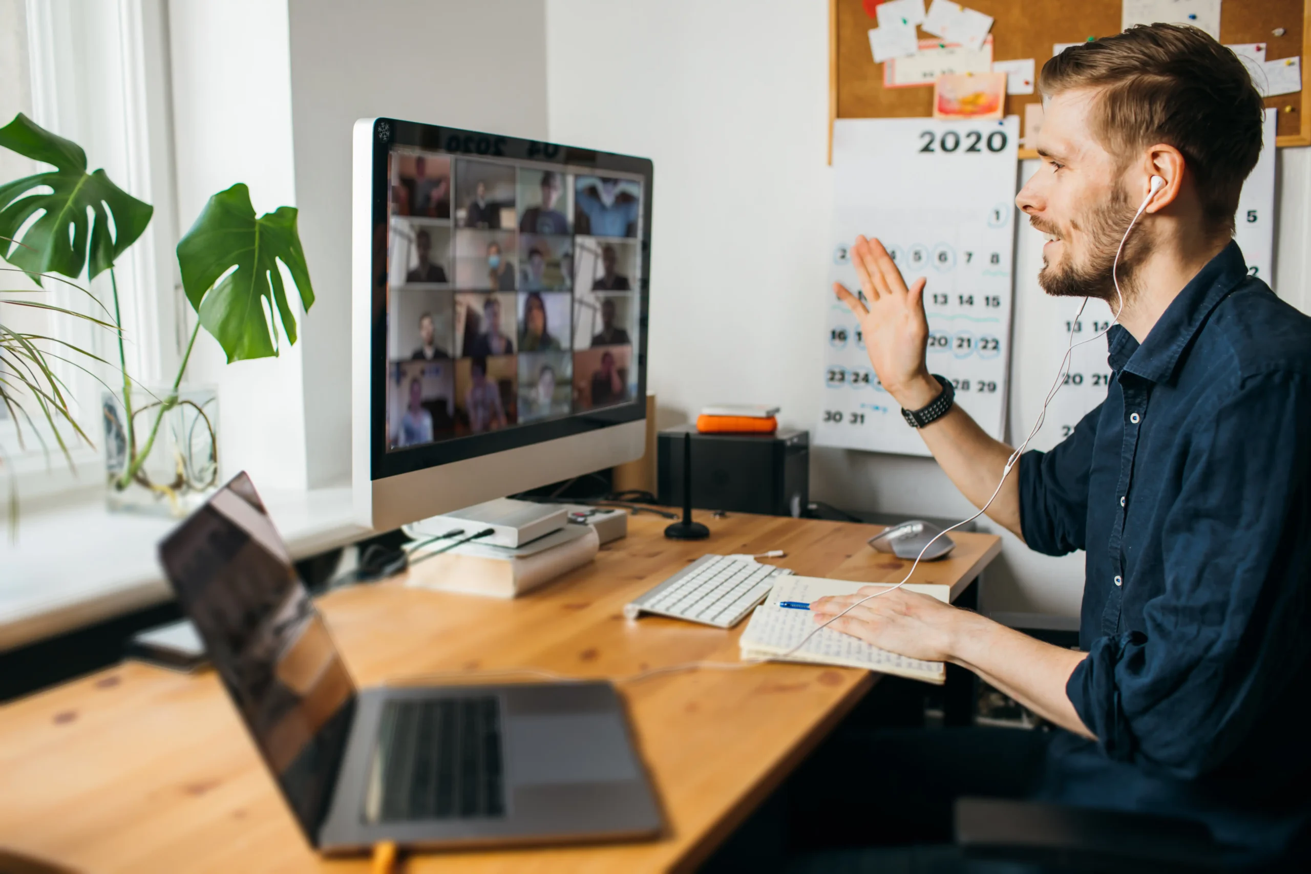 Man at home office on virtual meeting with headphones
