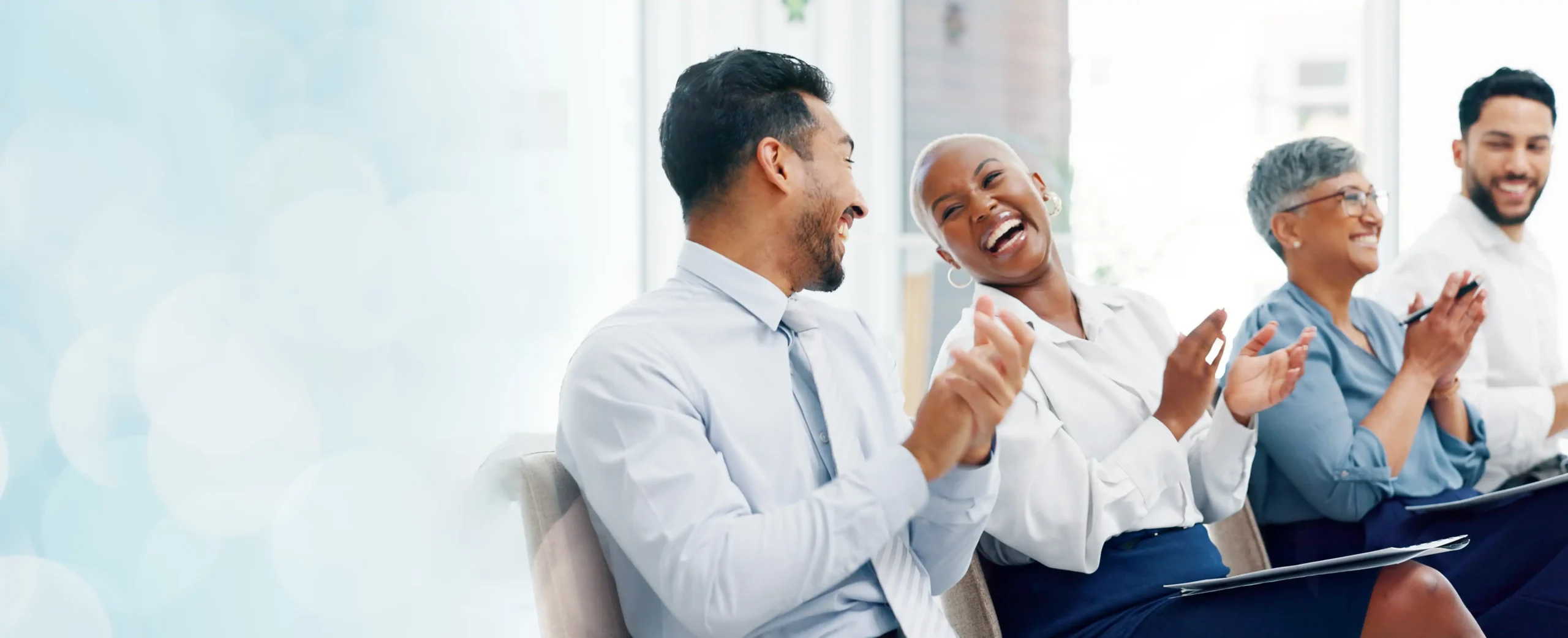 colleagues clapping and laughing at training event