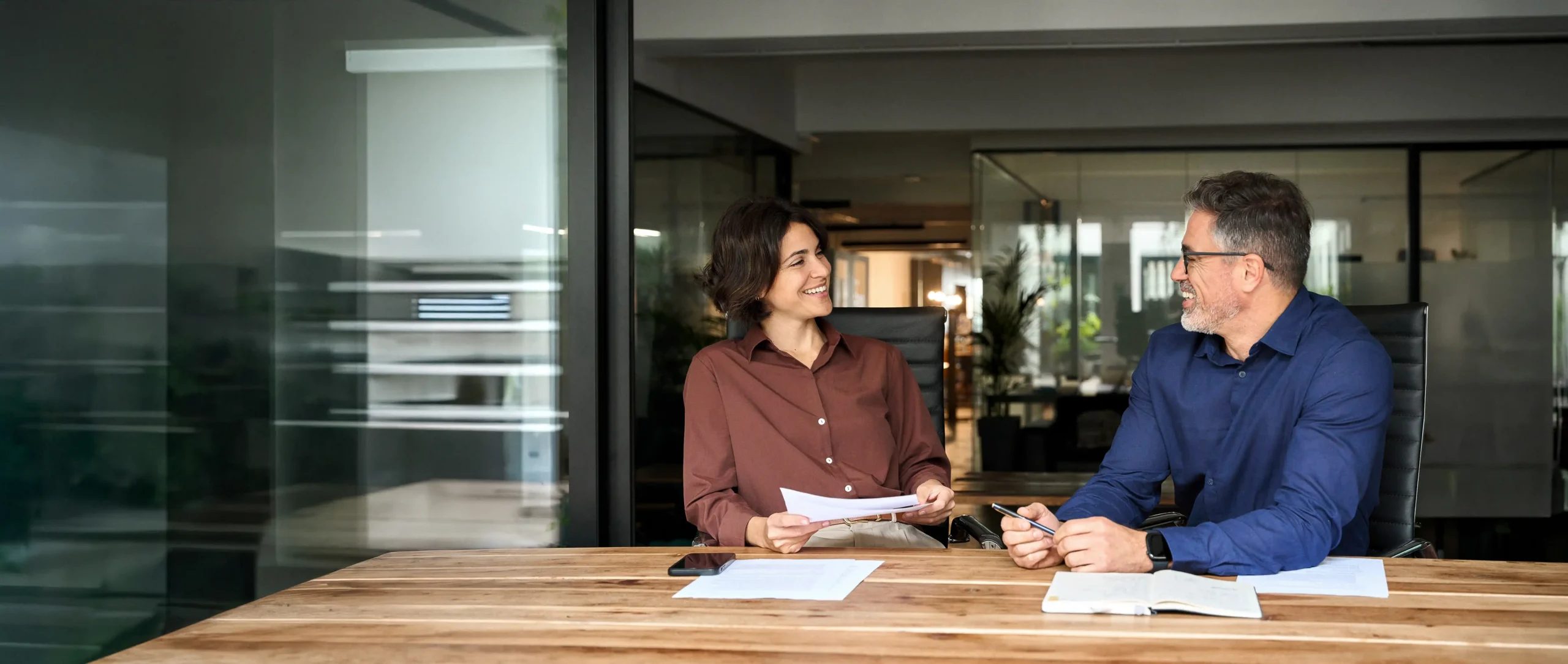 Coworkers in button up shirts at conference table