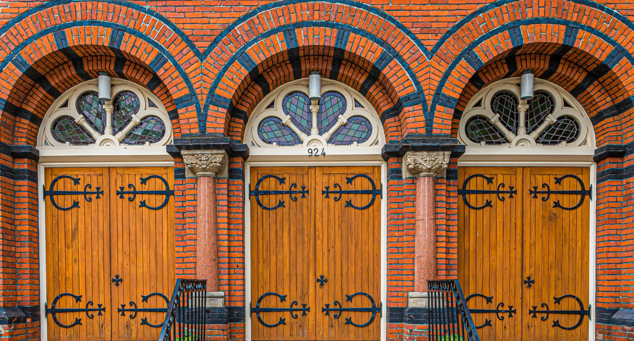 three fancy wooden doors on a church